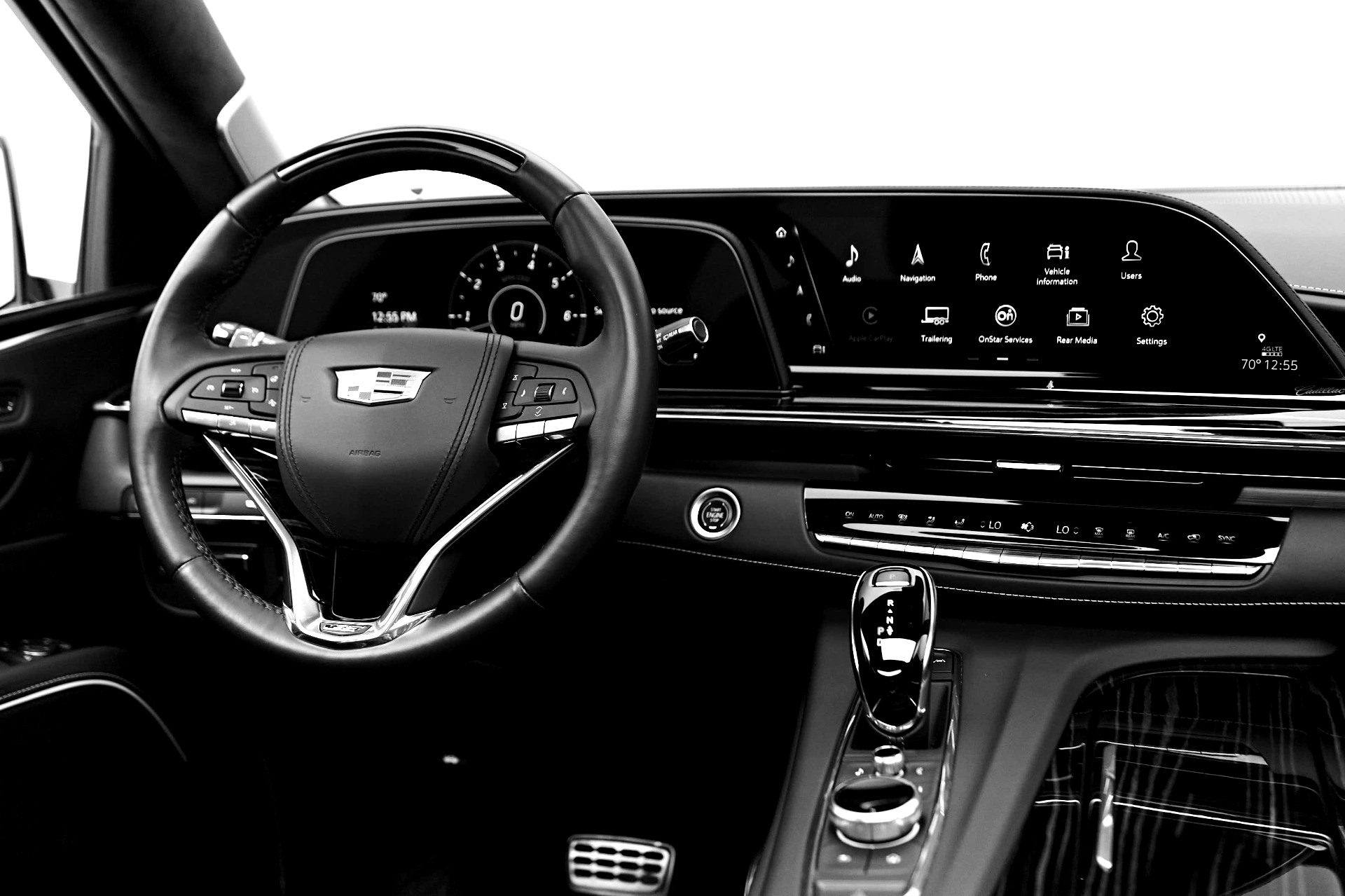 Full dashboard view: steering wheel, digital gauge cluster, and center console