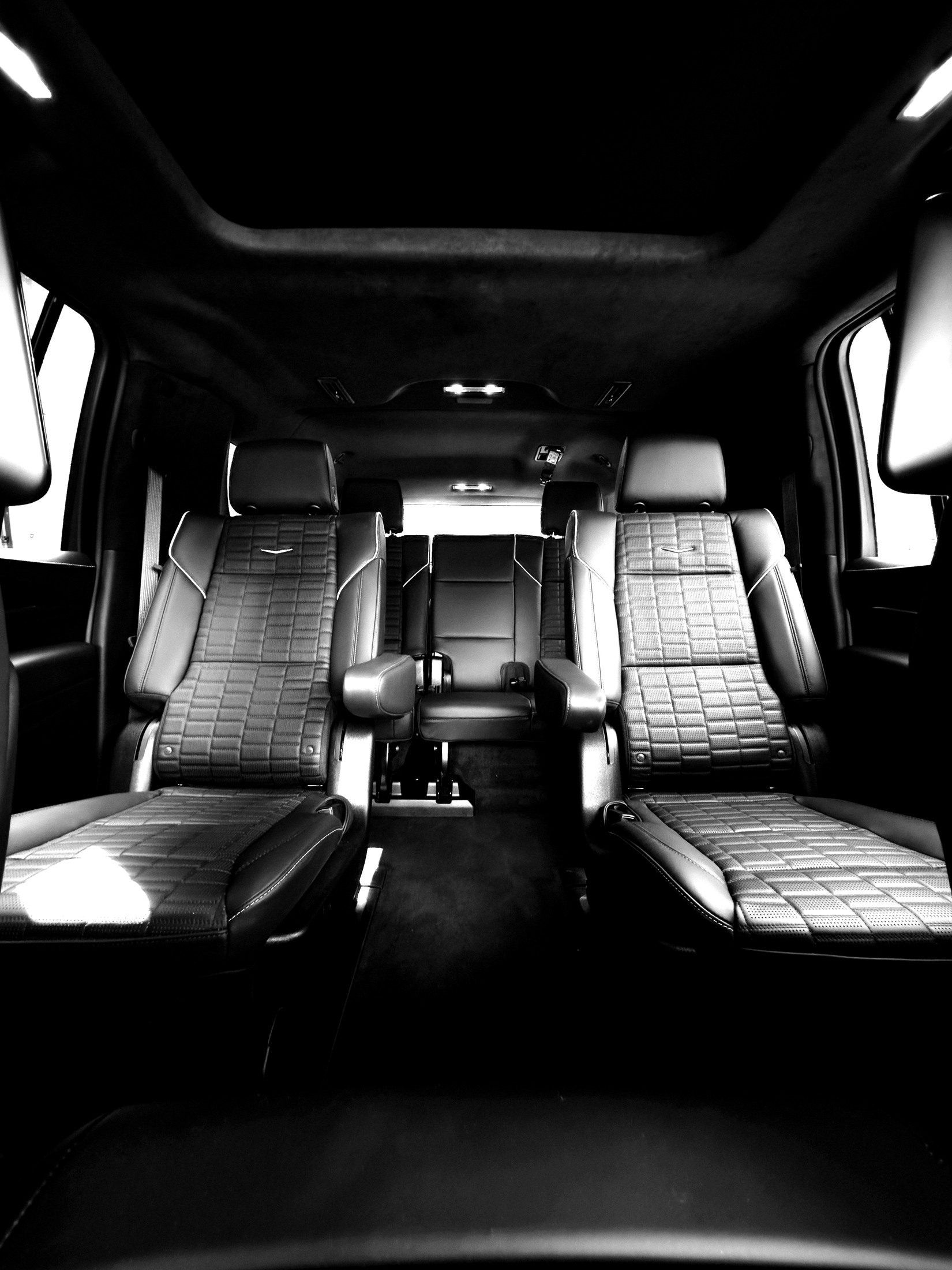 Empty rear cabin of the Escalade, quilted leather captain's chairs