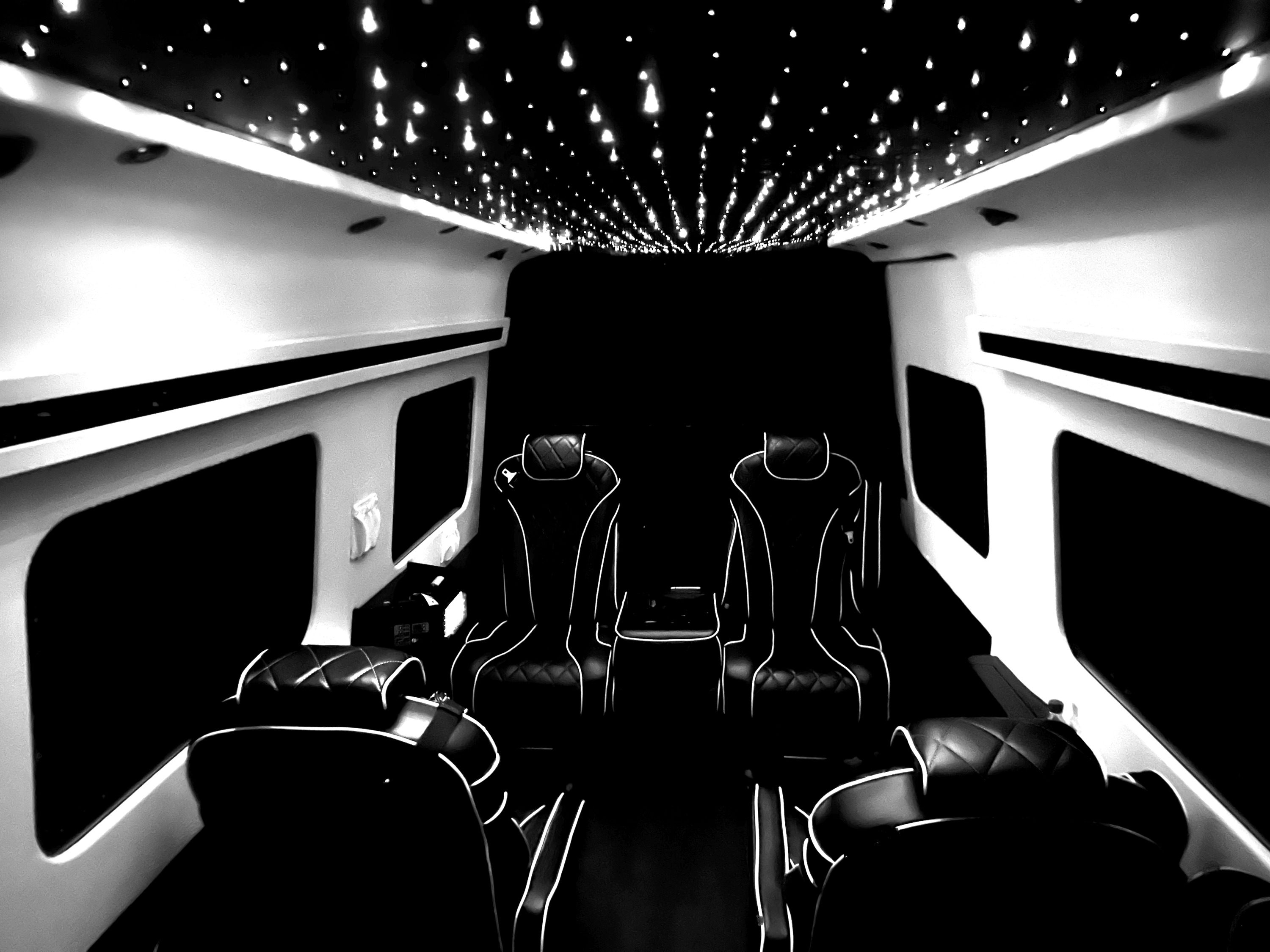 Interior of a Mercedes Sprinter van with a starlit fiber-optic ceiling